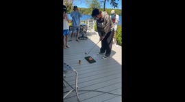 Fore! Right onto the grill: Guy hilariously golfs a frozen patty into perfection