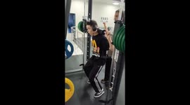 Man gets pinned during barbell squat on machine in Moscow, Russia