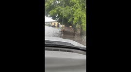 Driver splashes man floating in flood in Maracay, Venezuela
