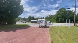 Mail truck leaving a office building parking lot