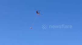 Helicopters dump water on Marseille wildfire to contain spread of flames