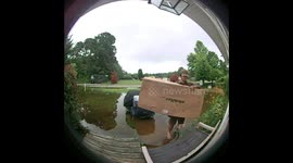 Determined UPS driver delivers heavy package through flooded yard in Virginia