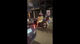 Toddler plays peek-a-boo while on motorcycle with father