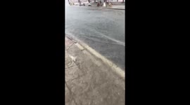Riding an Electric Scooter Through a Flooded Street