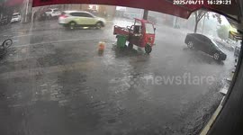 CCTV captures street being hit with flash flood during sudden downpour