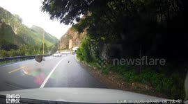 Rocks tumble down hillside onto road in China