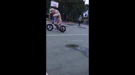 Determined dog pedals bicycle through park in Jiangsu, China