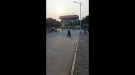 A Boy Slides Down the Slope on a Suitcase