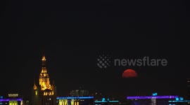 Russia: Full moon rises over Moscow skyline