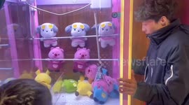 The Girl Wins a Plush Toy From the Caw Game