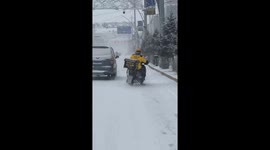A Delivery Man Wobbles Unsteadily on His Bike