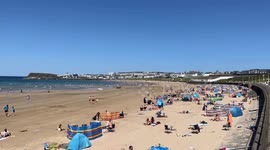 People enjoy the unusually warm weather at West Strand, Portrush as the town prepares for the 153rd Open Golf Championship starting tomorrow
