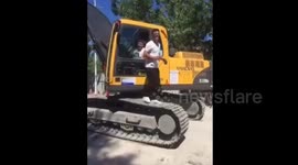 Man uses moving digger tracks as a treadmill to work out