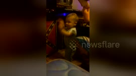Baby 'rocks out' to heavy metal while dad plays guitar