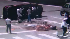 Car crashes central reservation and turns over