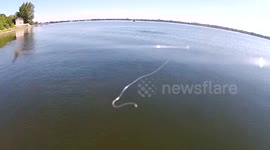 Man uses drone to catch a large fish in a lake