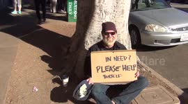 Homeless man gives out money