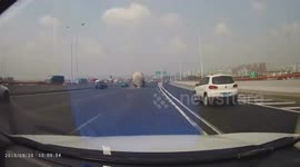 Tyre drops from tank truck driving on motorway