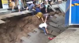 Sinkhole opens on street and injures two in China