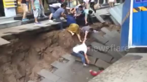 Sinkhole opens on street and injures two in China