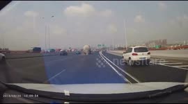 Tyre drops from tank truck driving on motorway