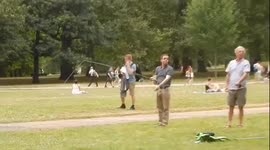 Men cast fishing lines onto grass