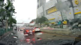 Dashcam captures winds tearing pieces from shopping mall facade
