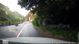 Rocks tumble down hillside onto road in China