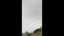 fire department helicopters dropping water | huge brush fire in hawaii on Oahu | 2 helicopters trying to extinguish fire | multiple fire trucks sighted in area