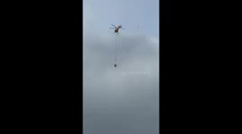 fire fighter helicopter drops water on wildfire on Oahu | multiple helicopters needed to put out fire on Oahu