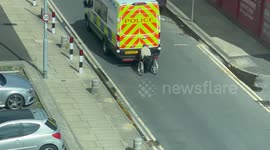 Moment wheelchair user clings to moving police van in ‘Back to the Future’ stunt