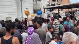 Residents at UNRWA shelter in Khan Younis queue for clean water