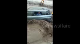 Heroic locals step in to rescue motorist trapped in car swept away by raging floodwater