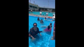 Woman loses balance while lifting child in pool in Uzynagash, Kazakhstan