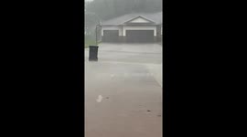 Heavy downpour and wind blur visibility in Norfolk, Nebraska