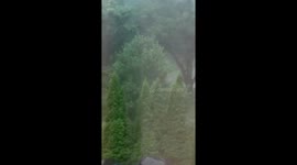 Vehicle drives through flooded road during intense storm in Moline, Illinois, USA