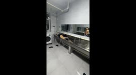 Men playfully swim in laundry trough in Liaoning Province, China