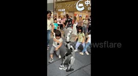Little girl attempts to trip up robot, ends up getting her foot trod on