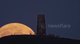 The Moon rises over Glastonbury Tor, Somerset, UK, on July 9th, 2025.