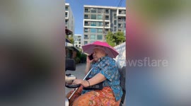 Three grannies ride their electric scooters in convoy