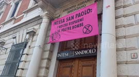 Italy: Activists Scale Bank Building and Drop Grenade-Shaped Piggy Bank in Protest Against Fossil Fuel and Arms Investments