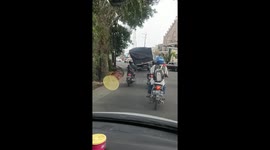 Motorists stay well back as wonky truck wobbles along road