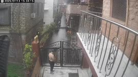 Wall collapses from the weight of floodwater in India