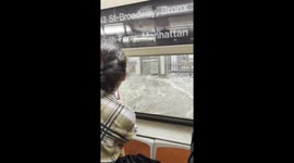 Floodwater rushes onto carriages in New York's metro