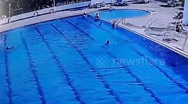 Quick-thinking security guard leaps into pool to rescue struggling child