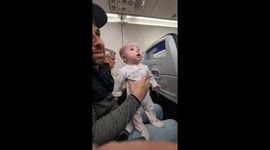 Baby Captivated by Flight Safety Demonstration