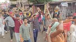 Devotees coil live snakes around the necks during bizarre Hindu festival in Bihar