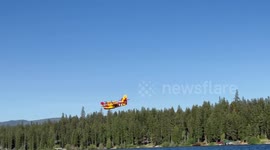 US: Aircraft Scooping Water From Placid Lake To Battle Garnet Fire