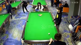When it rains! Girl gets struck by pool ball... then whacked by a second wayward shot