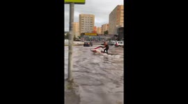 Man rides jet ski through flooded streets in Penza, Russia